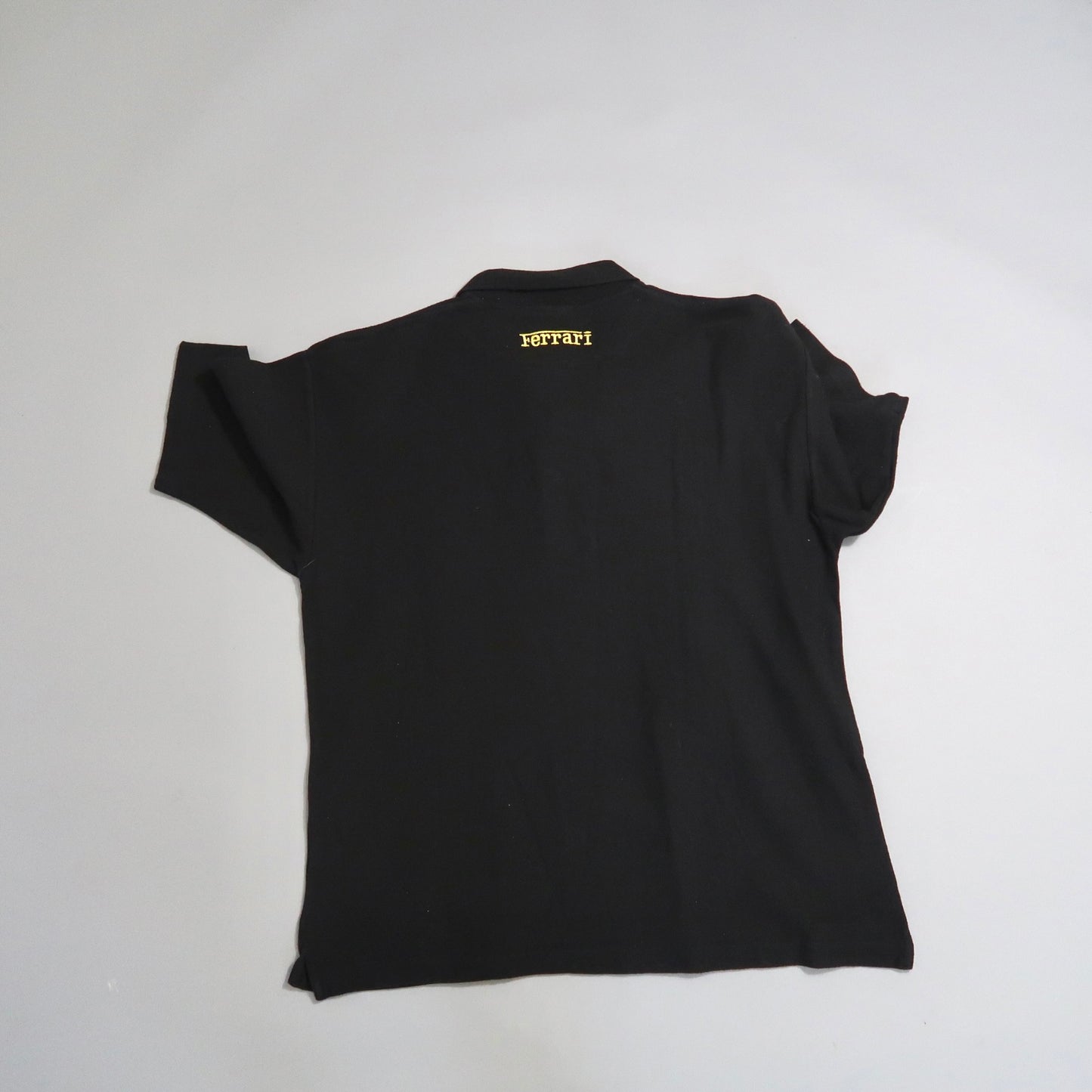 Black shirt with yellow nullFerrarinull text on the back.