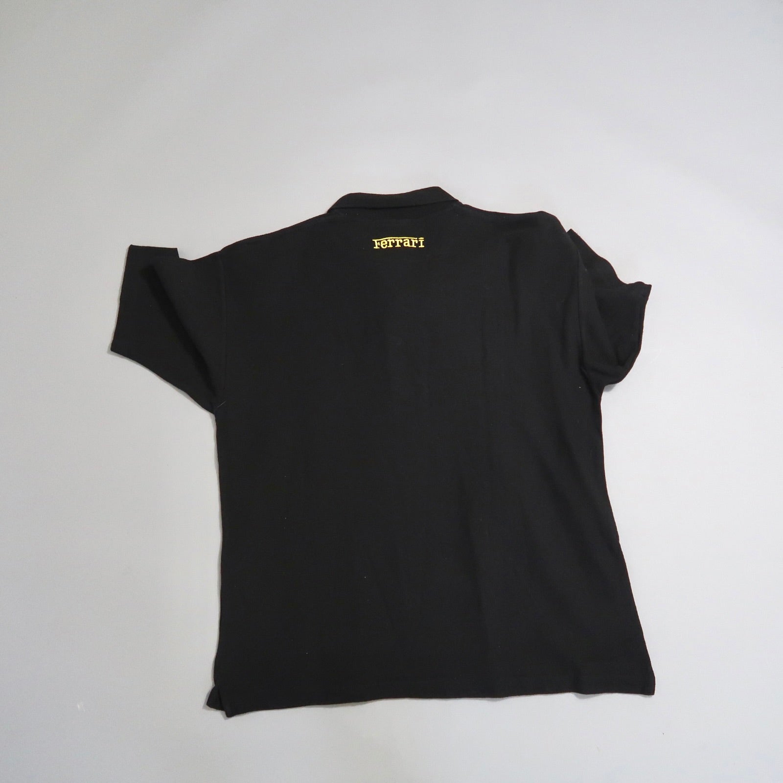 Black shirt with yellow nullFerrarinull text on the back.