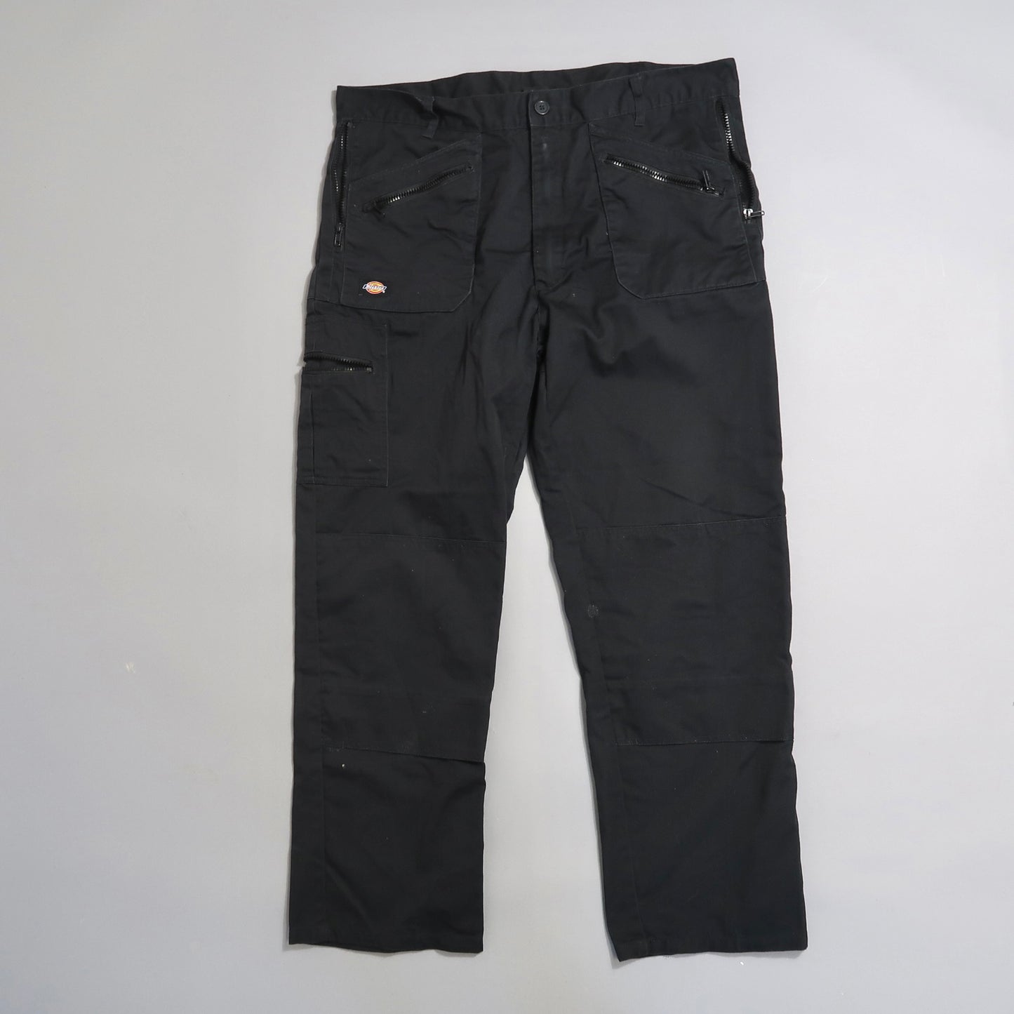 Black cargo pants with multiple pockets on display.