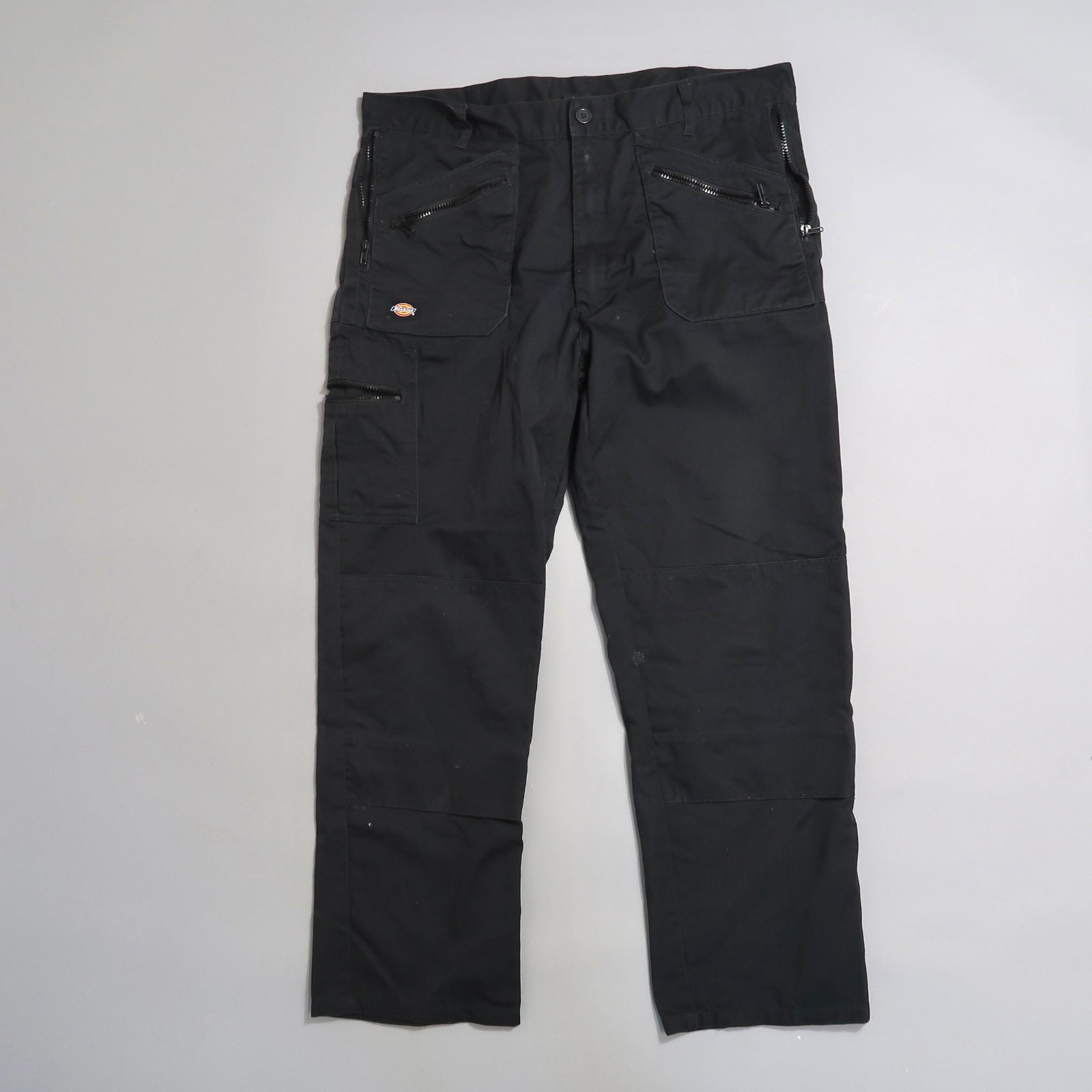 Black cargo pants with multiple pockets on display.