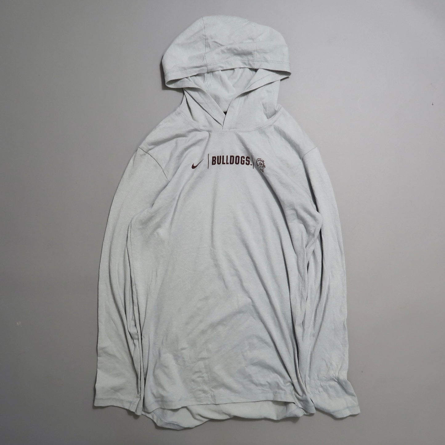 Gray hoodie with nullBulldogsnull and logo, placed on a plain surface.