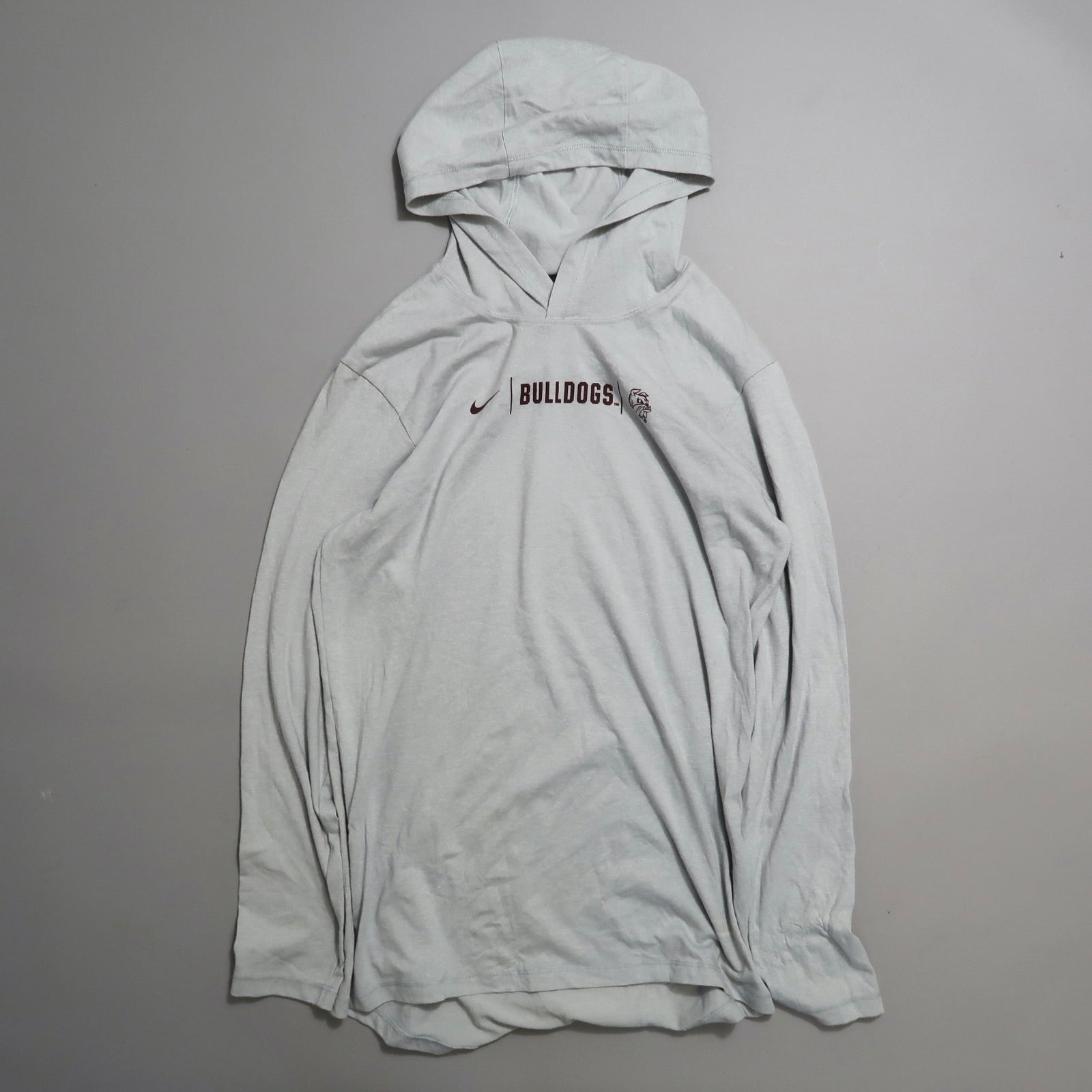 Gray hoodie with nullBulldogsnull and logo, placed on a plain surface.