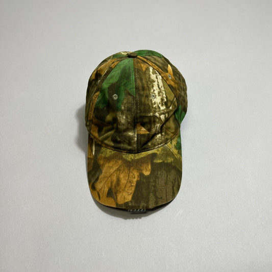 Camouflage baseball cap on a plain gray background.