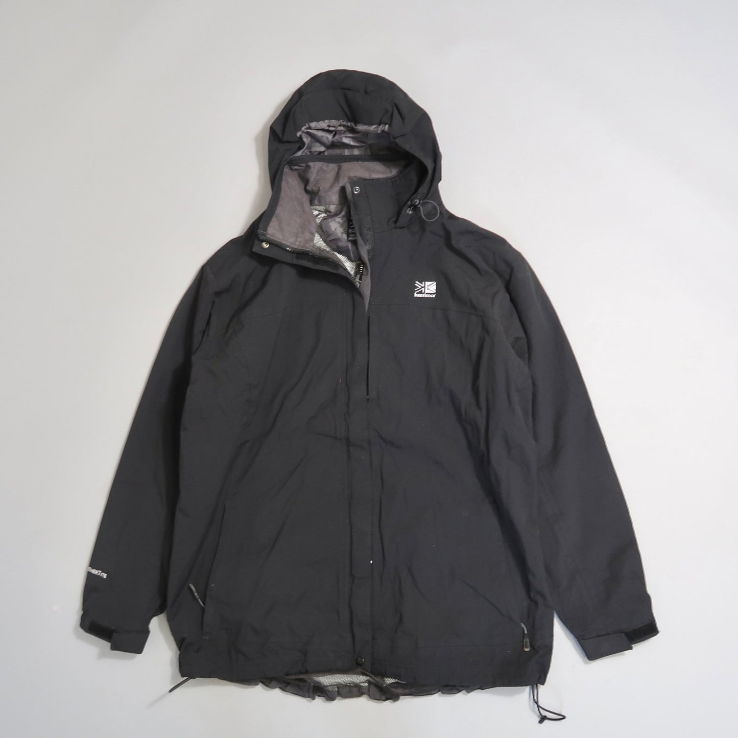 Black hooded jacket on a gray background.