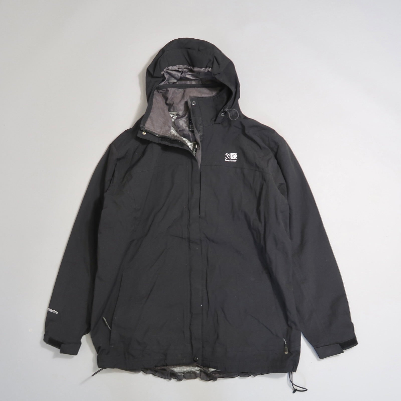 Black hooded jacket on a gray background.
