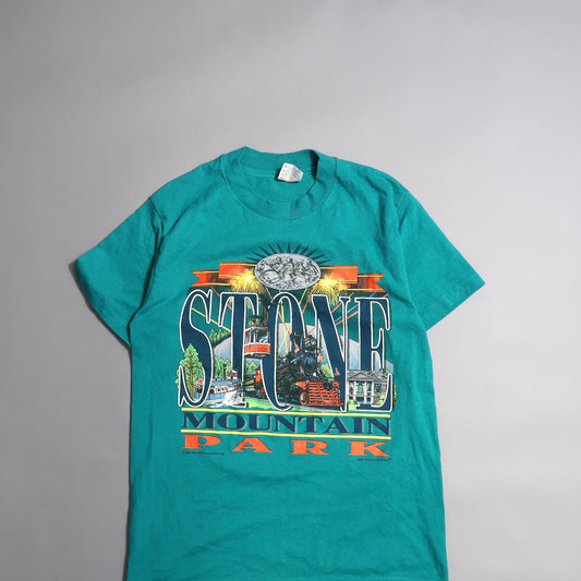 Teal T-shirt featuring Stone Mountain Park graphic design.