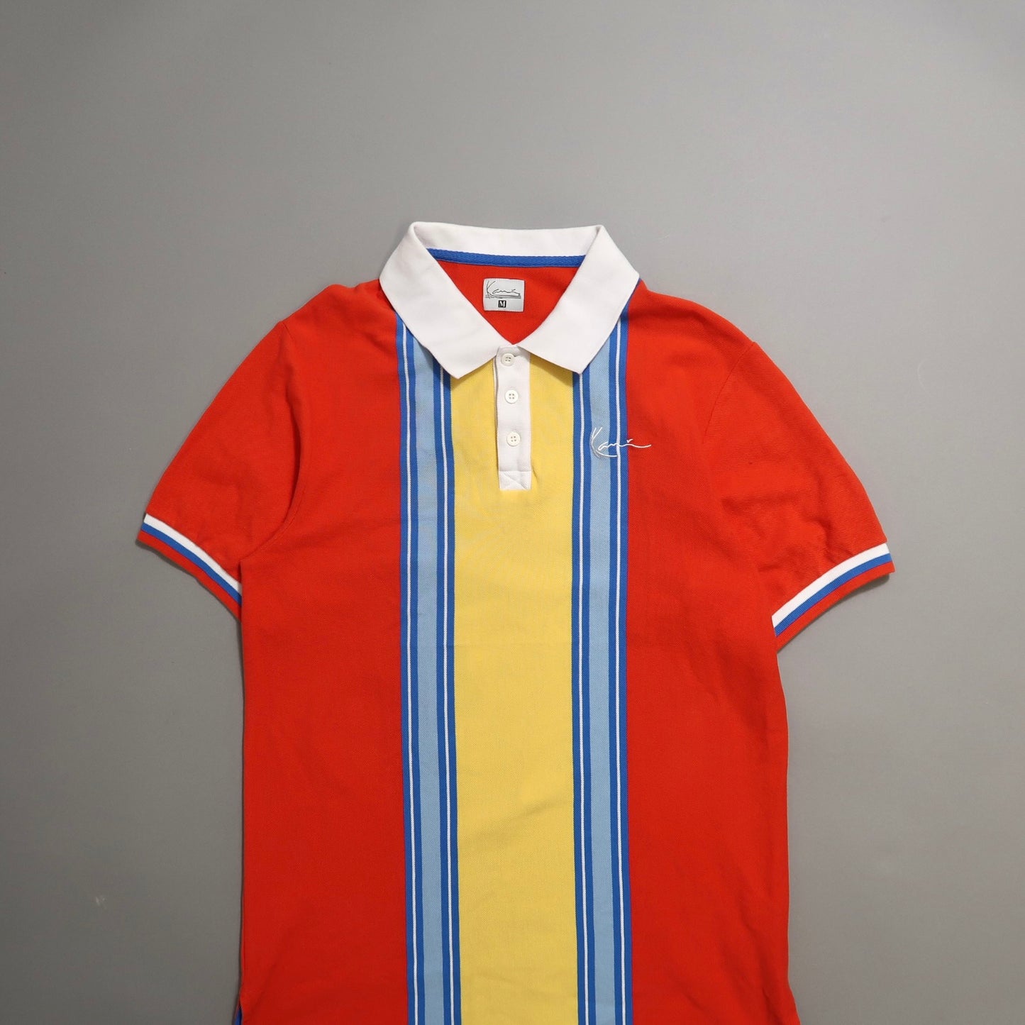 Colorful polo shirt with vertical stripes and white collar.