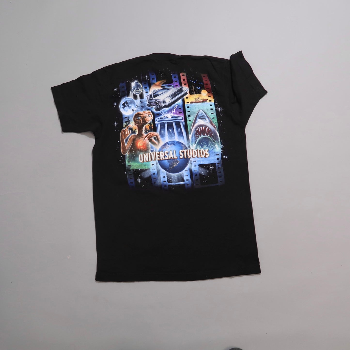 Black t-shirt with Universal Studios-themed graphics.