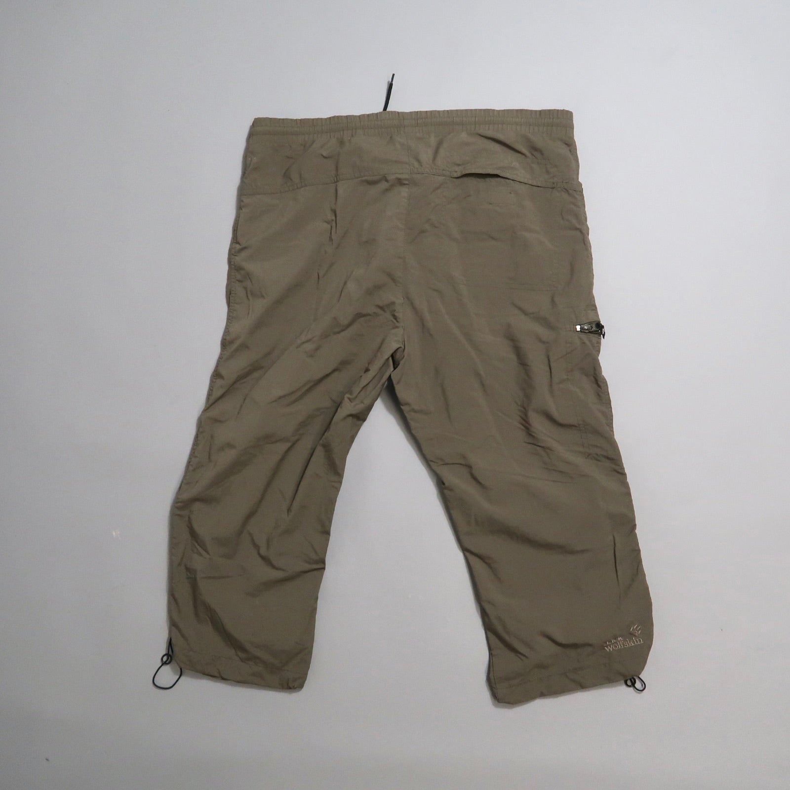 Khaki capri pants laid flat on a white background.