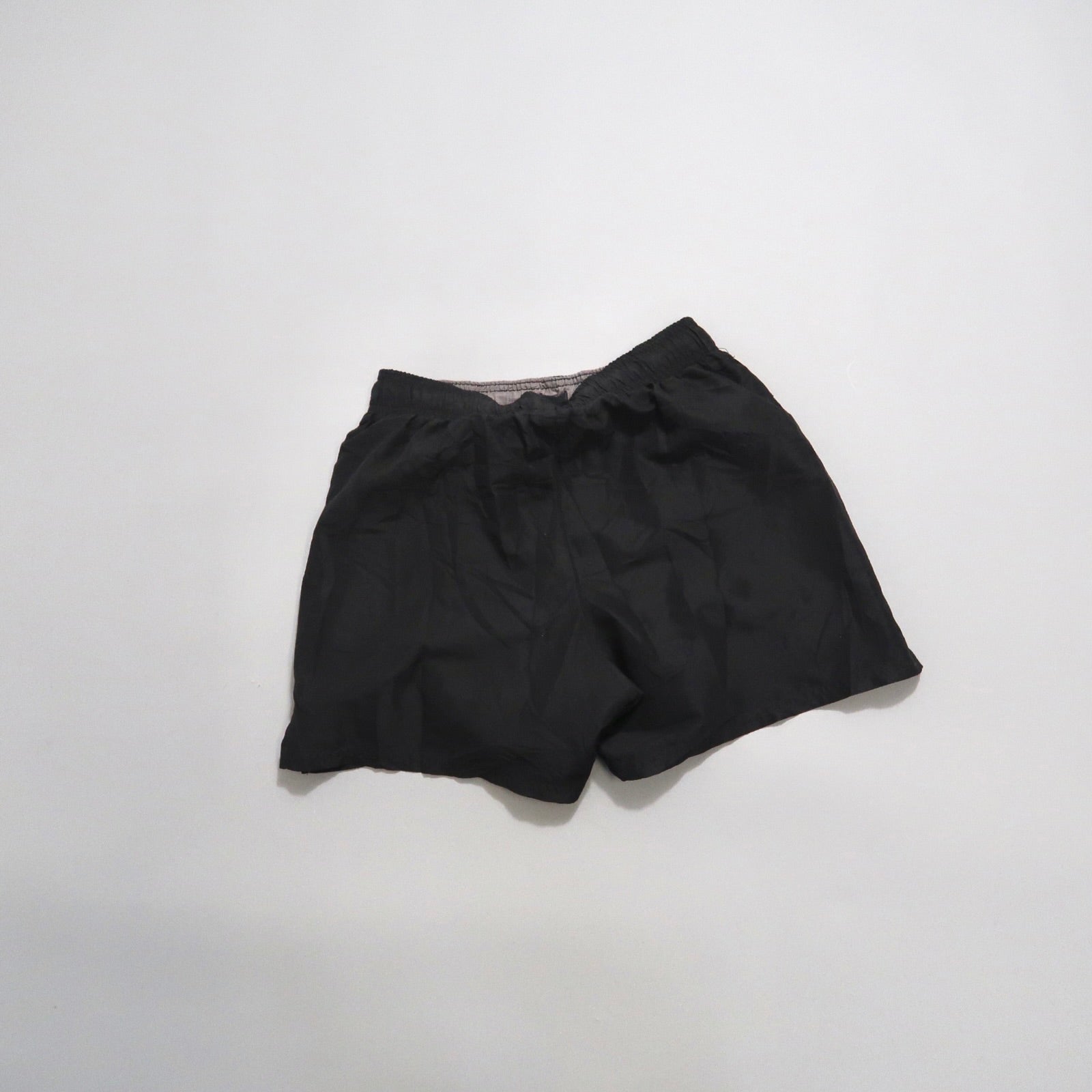Black athletic shorts on a plain white background.