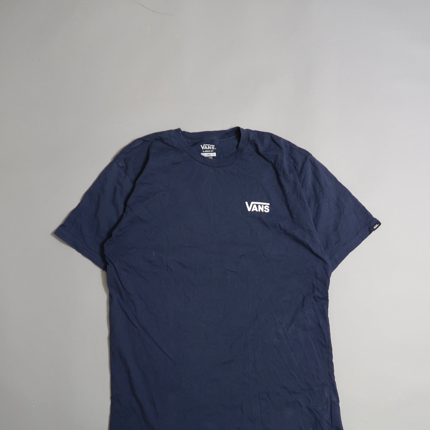 Navy blue Vans t-shirt with logo on a plain background.