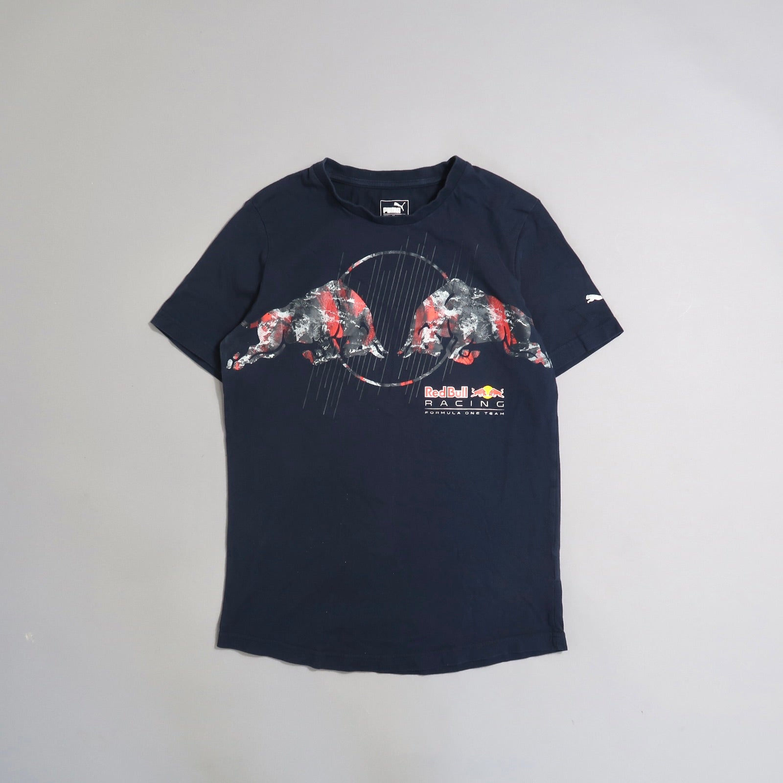 Navy Puma T-shirt with Red Bull Racing logo and abstract bull design.