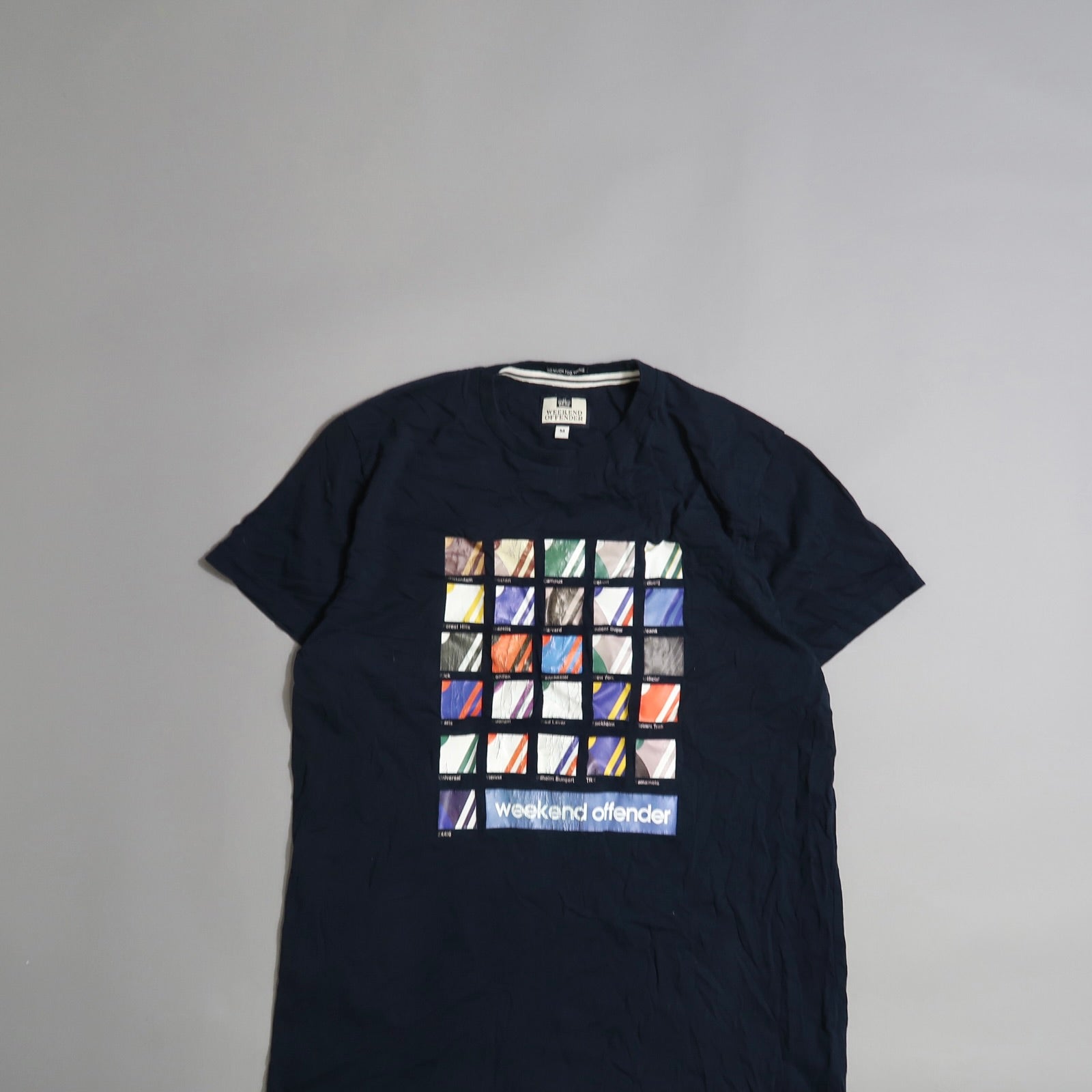 Navy t-shirt with colorful square pattern and nullweekend offendernull text.