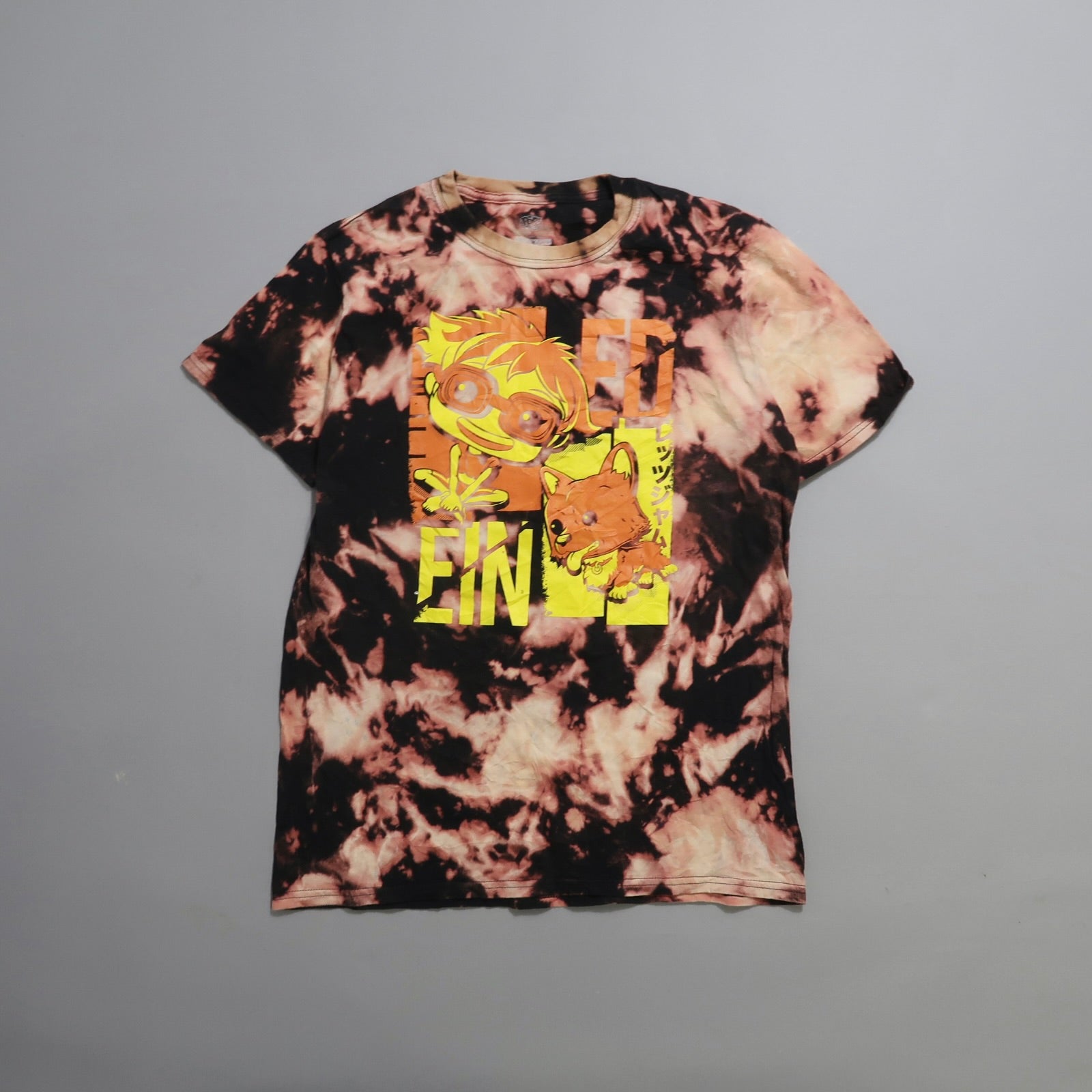 Tie-dye shirt with cartoon characters and bold yellow text.