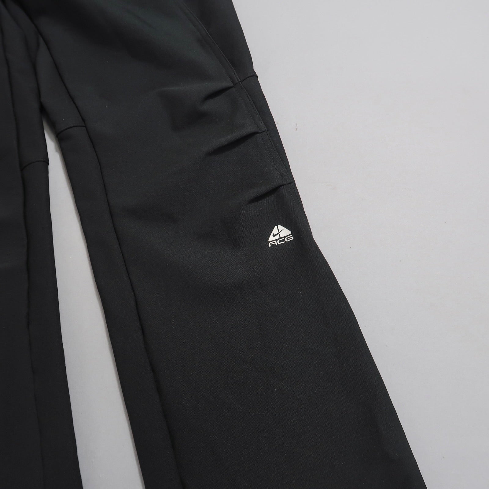 Black pants with ACG logo on a light gray background.