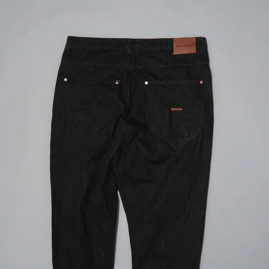 Black jeans with back pockets and a brown leather patch.