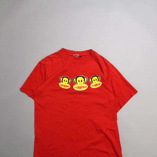 Red T-shirt featuring three cartoon monkey faces.