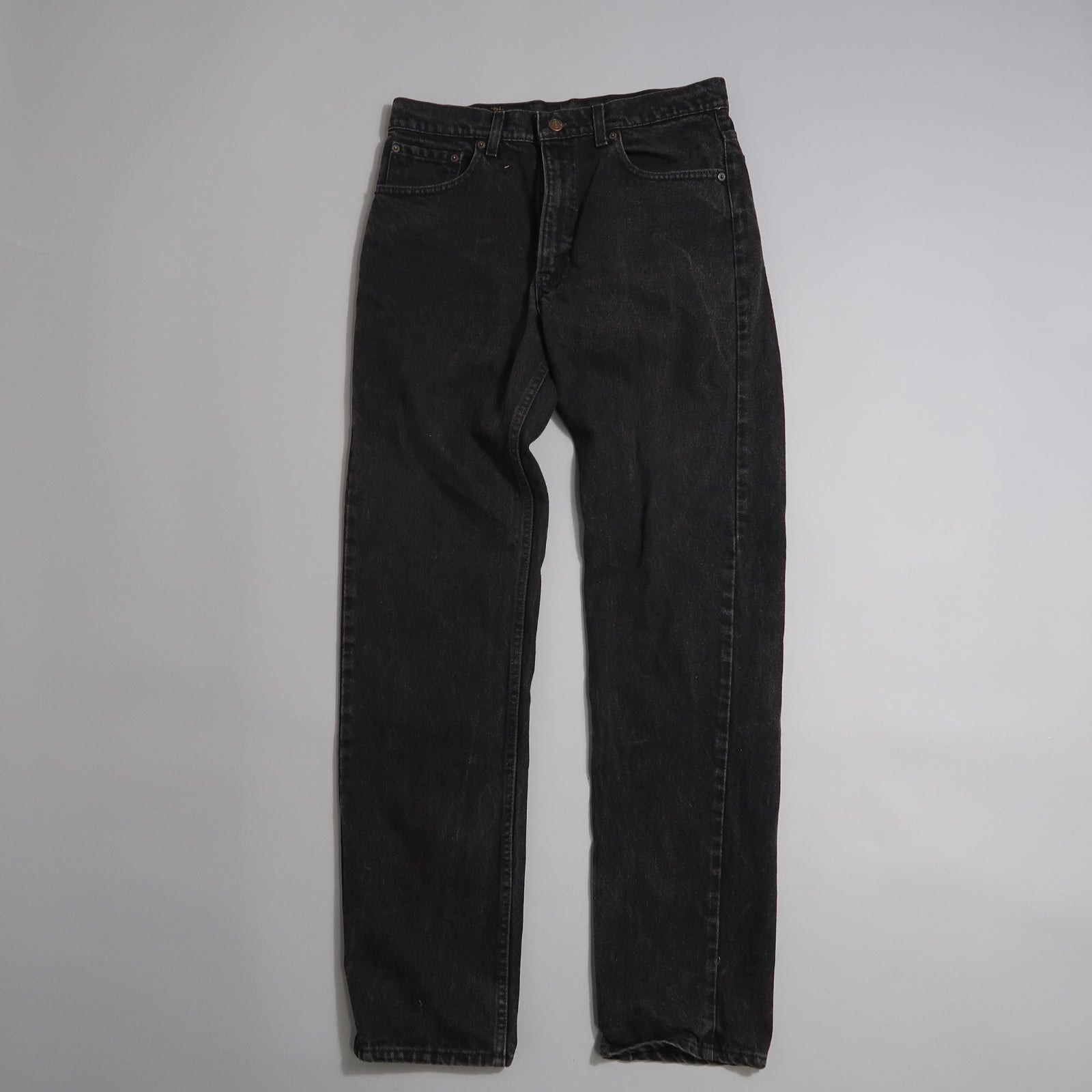 Black denim jeans on a plain white background.