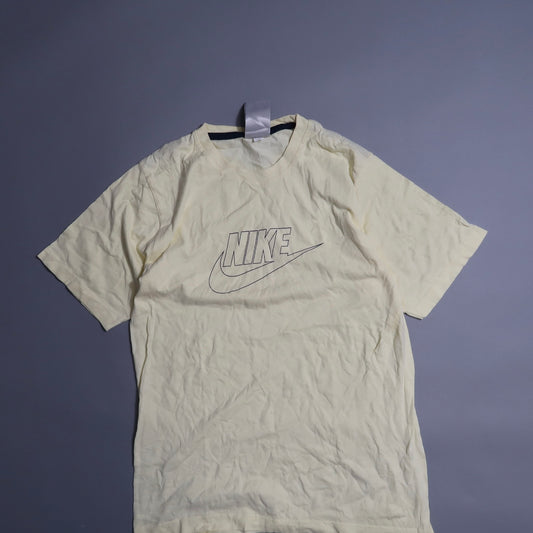 Cream Nike T-shirt with logo on plain background.
