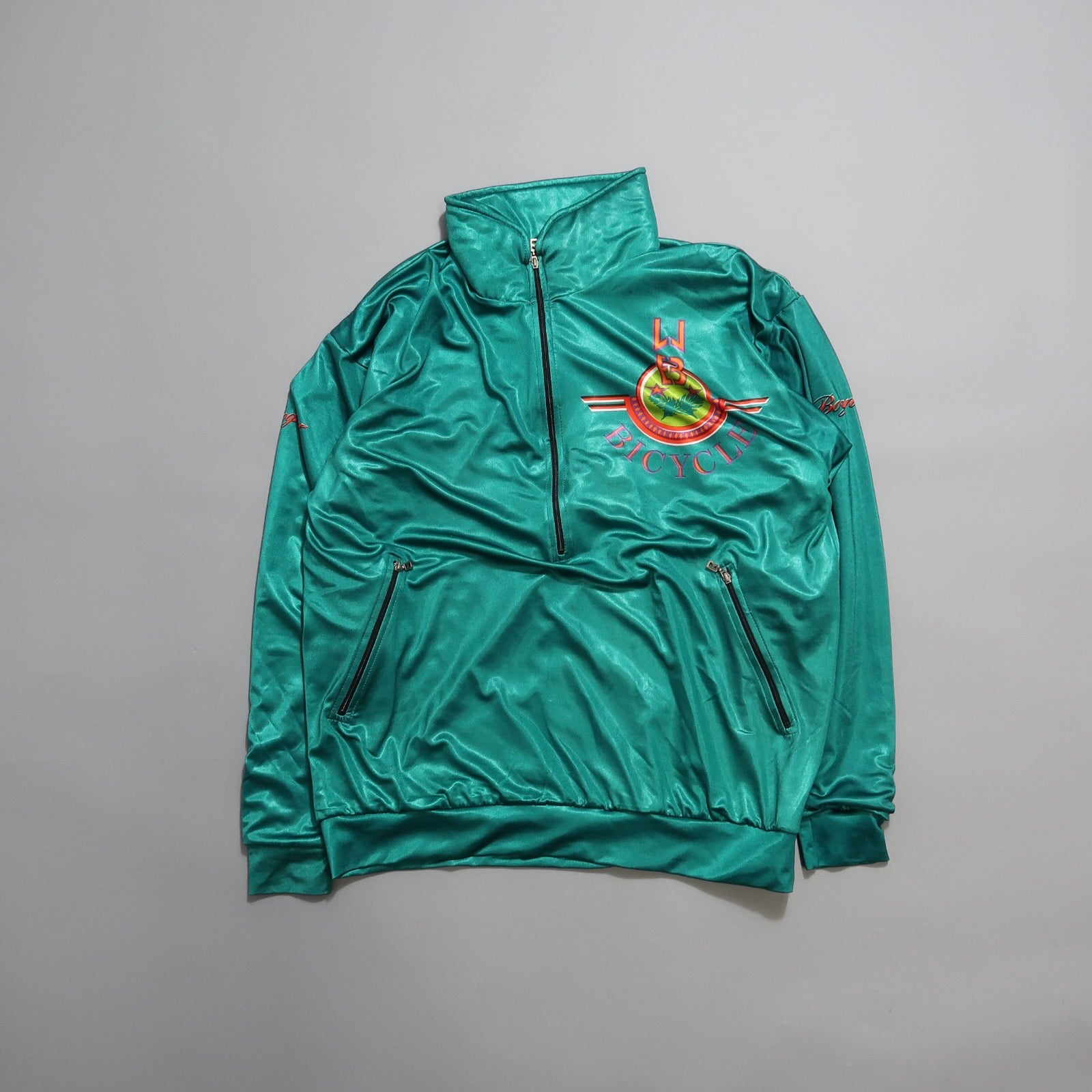Green zip-up jacket with bicycle club logo and chest embroidery.