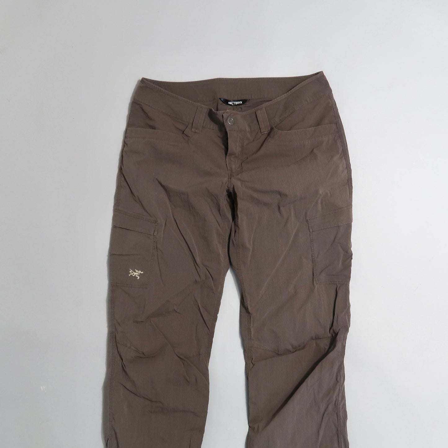 Brown cargo pants with pockets on a white background.