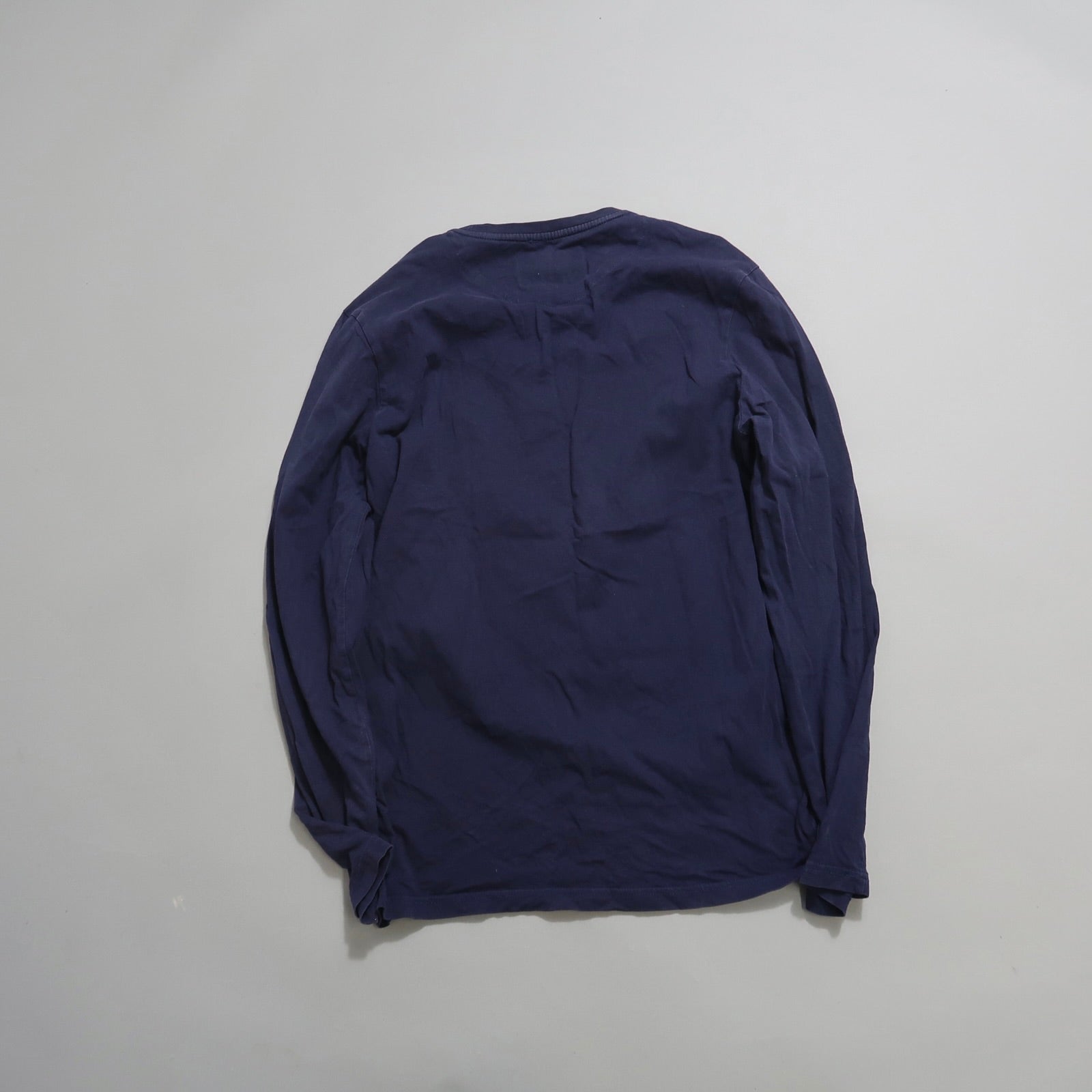 Navy blue long-sleeve shirt laid flat, back view.