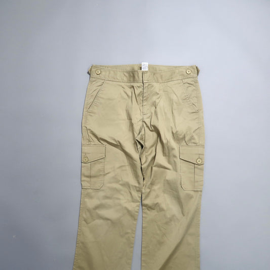 Khaki cargo pants with buttoned pockets on a gray background.