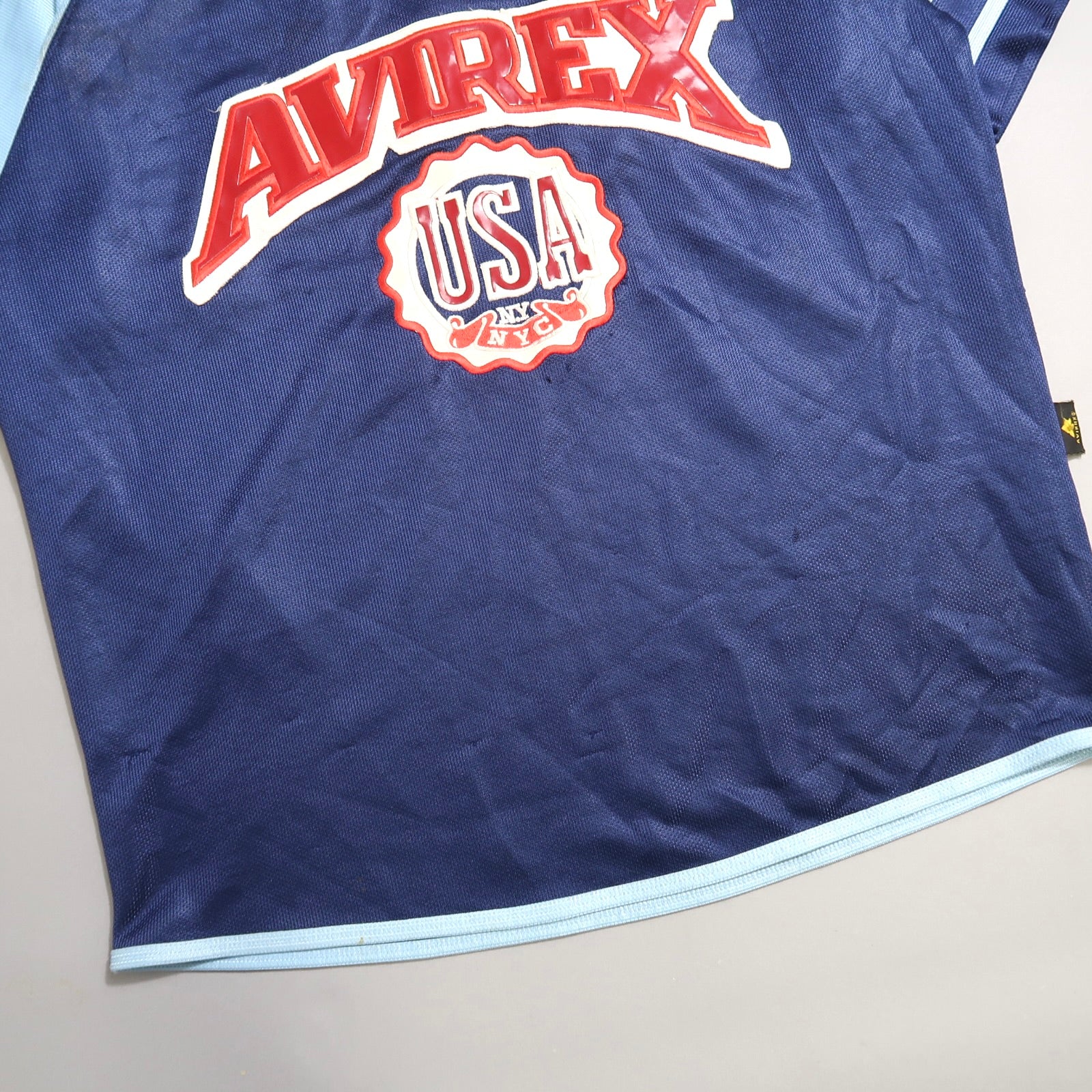 Blue Avirex USA shirt with red and white logo.