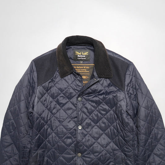 Navy quilted Barbour jacket with corduroy collar.