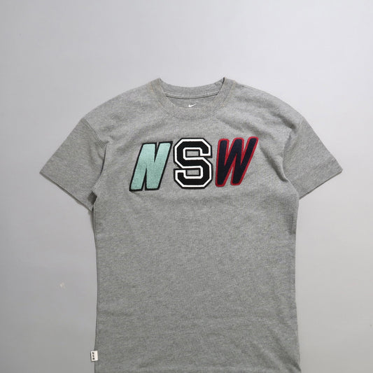 Gray T-shirt with nullNSWnull in colored block letters.