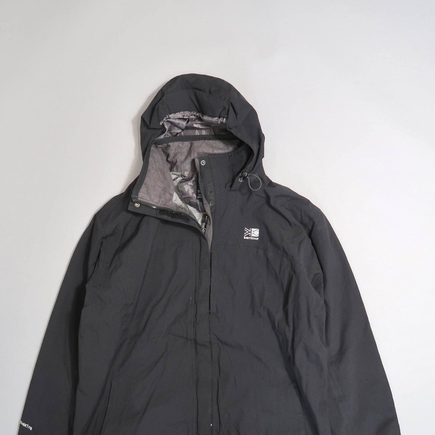 Black hooded jacket with a logo on the left chest.