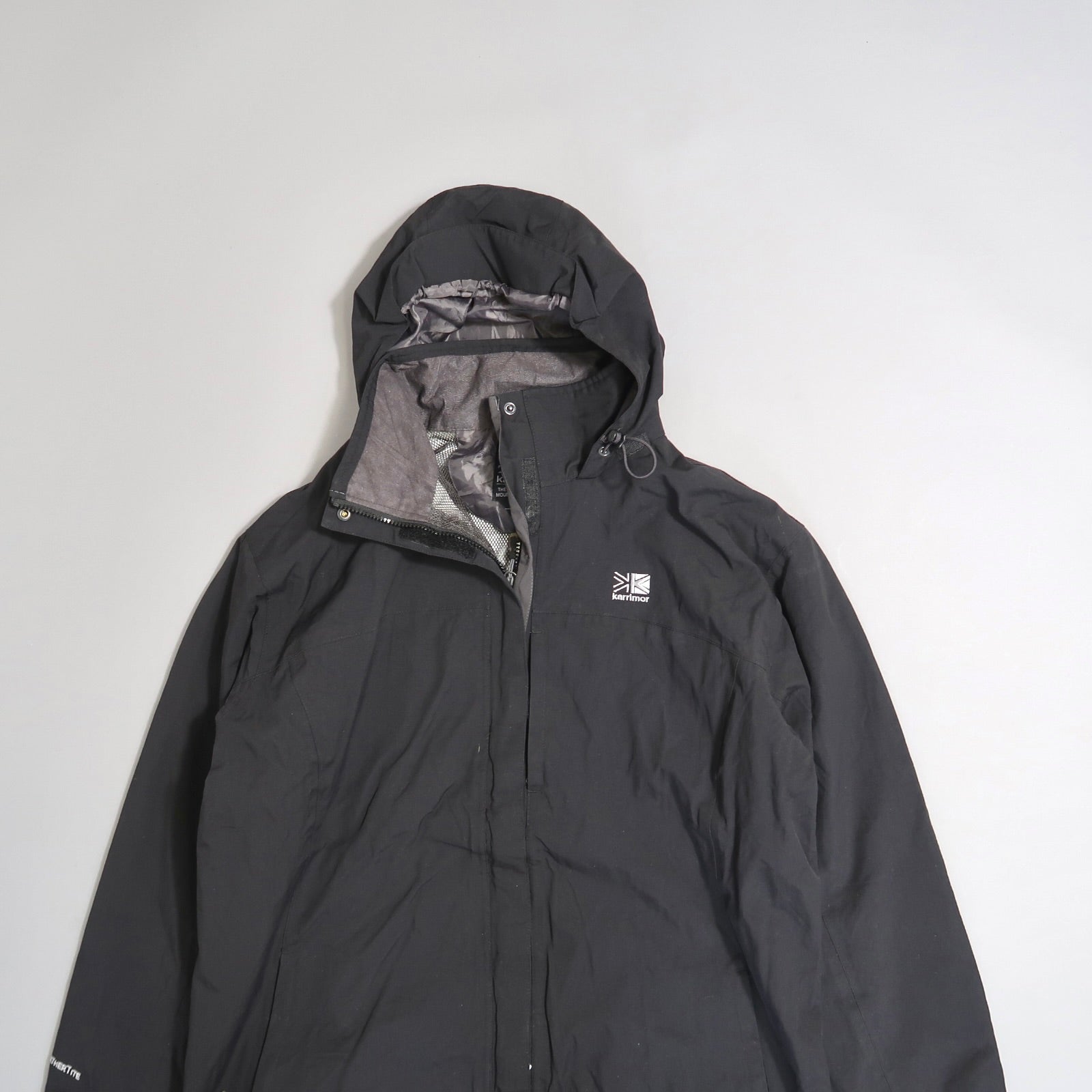 Black hooded jacket with a logo on the left chest.