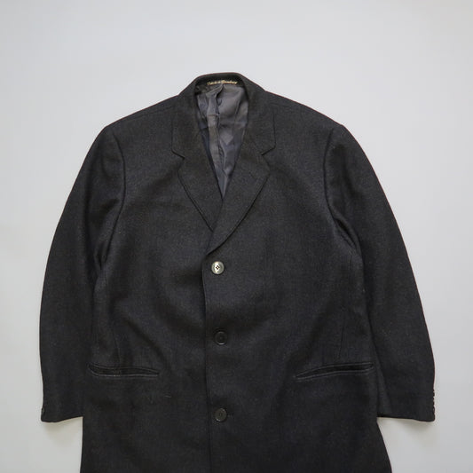 Dark gray blazer with three buttons on a white background.
