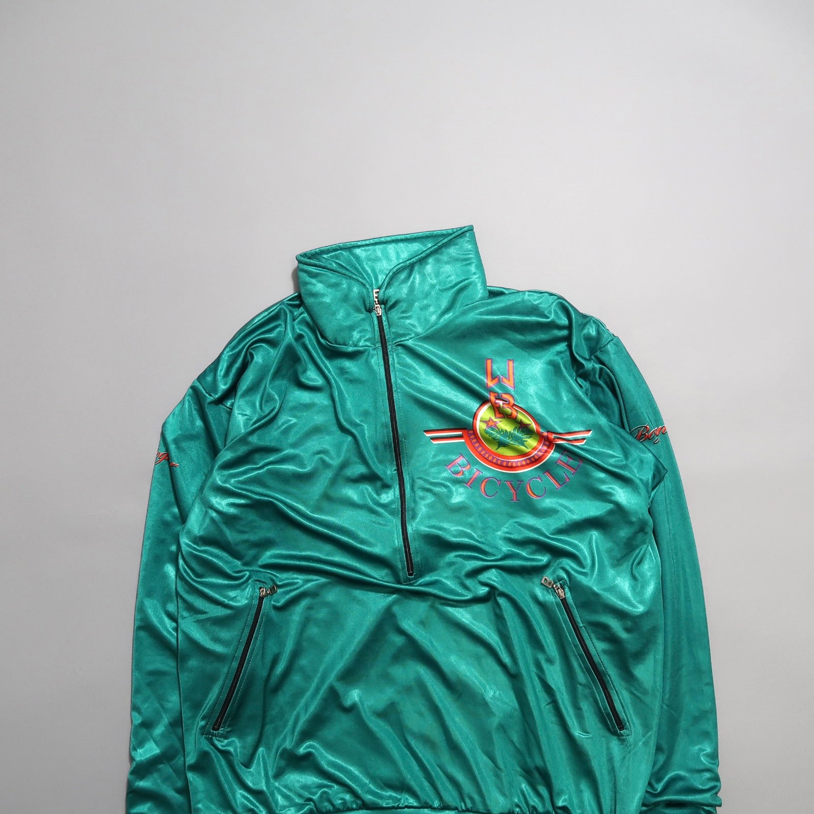 Green jacket with red and yellow nullBicyclenull logo on the front.