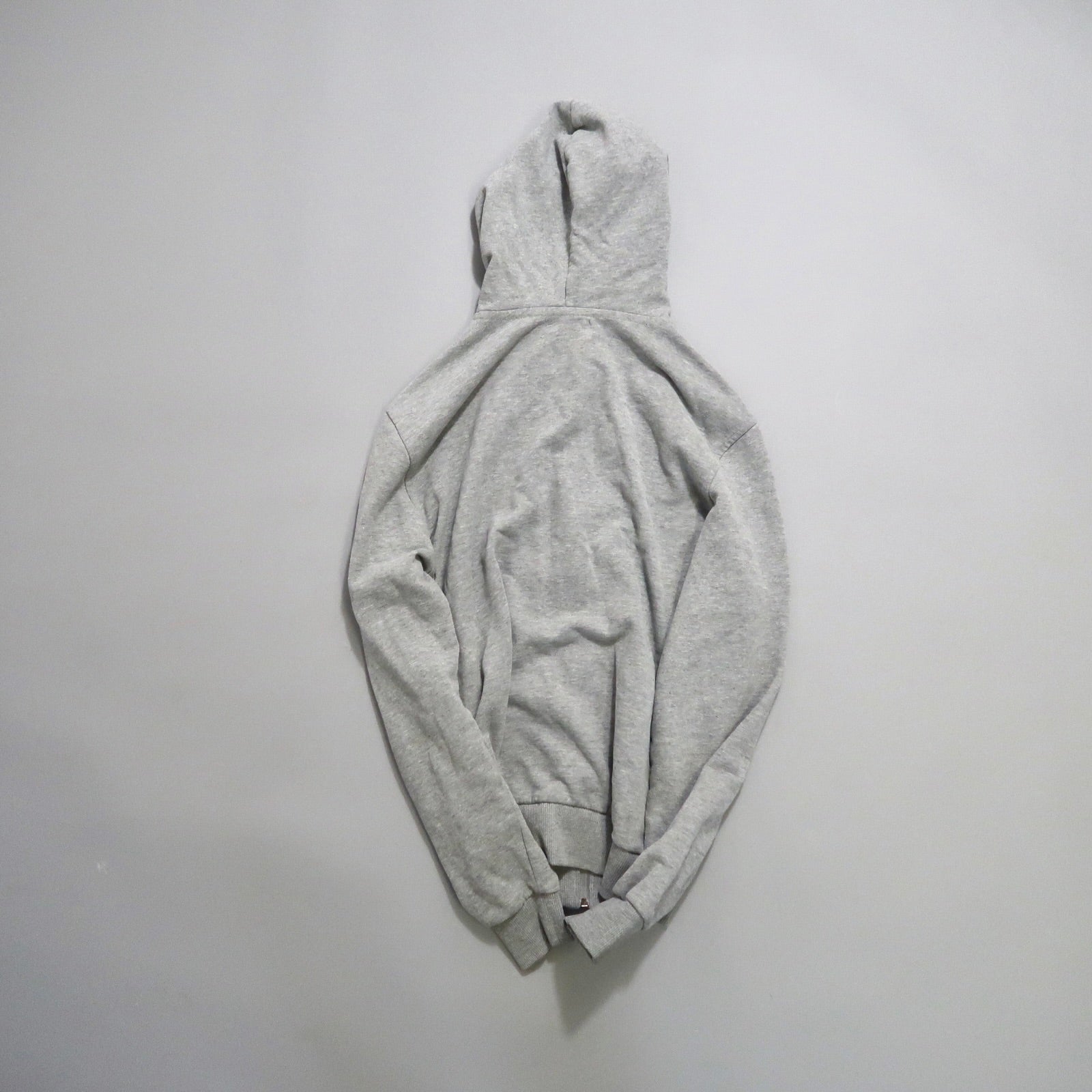 Gray hoodie laid flat on a light background.