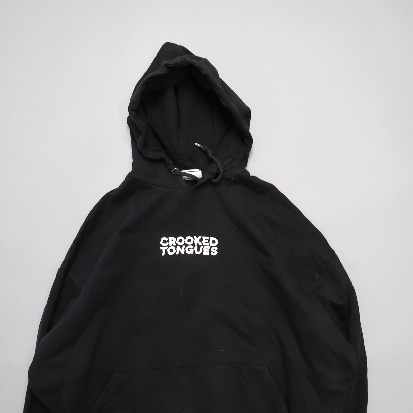 Black hoodie with nullCROOKED TONGUESnull text on the front.