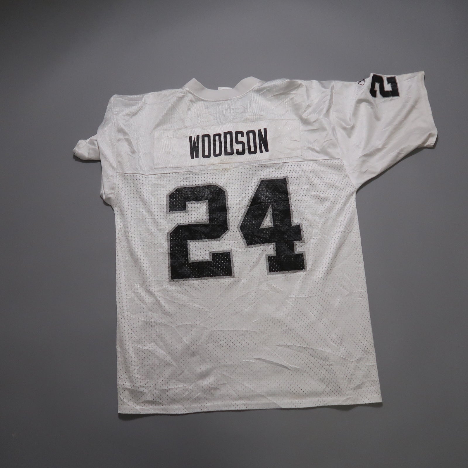 White jersey with the name nullWoodsonnull and number null24null in black.