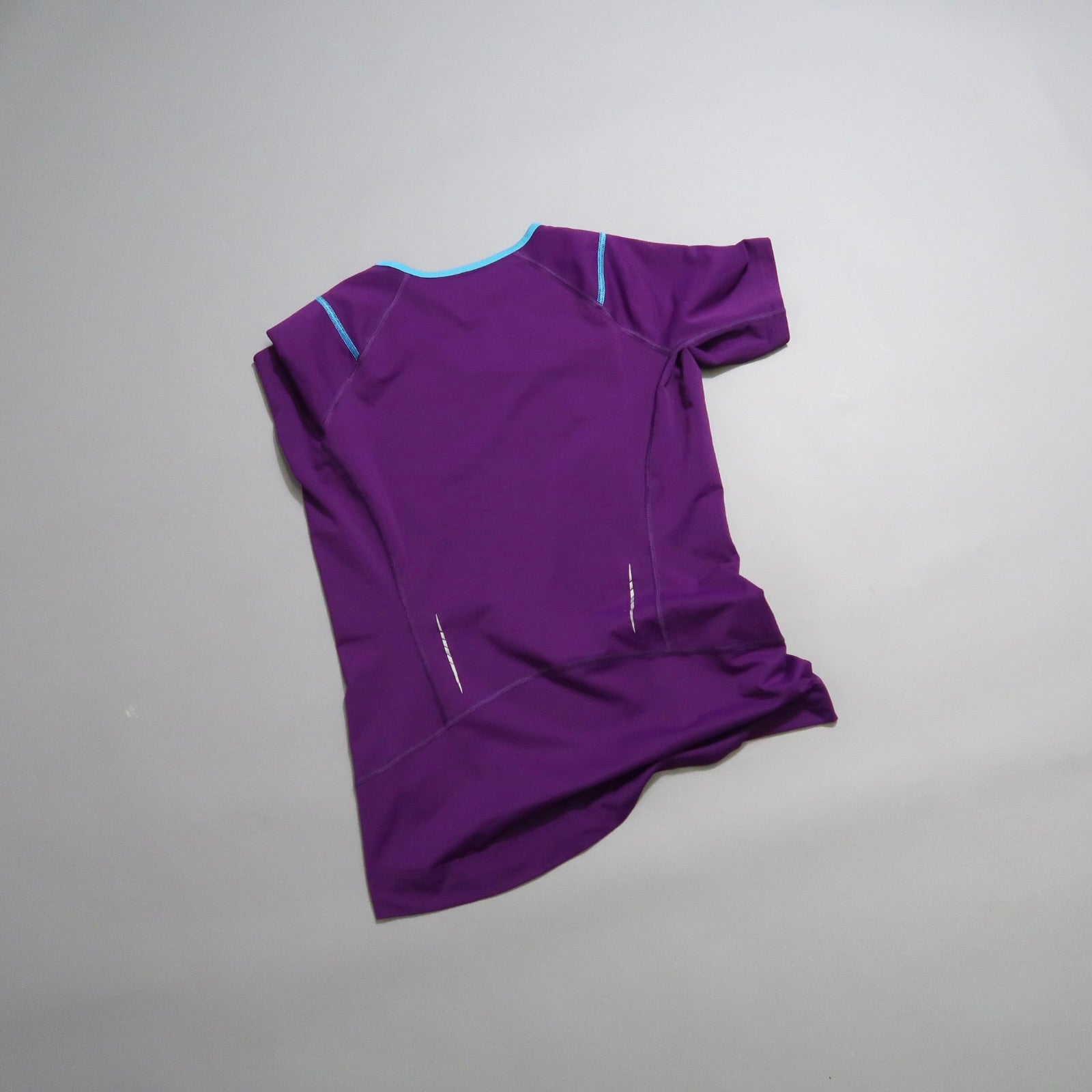 Purple athletic t-shirt with blue accents on a gray background.