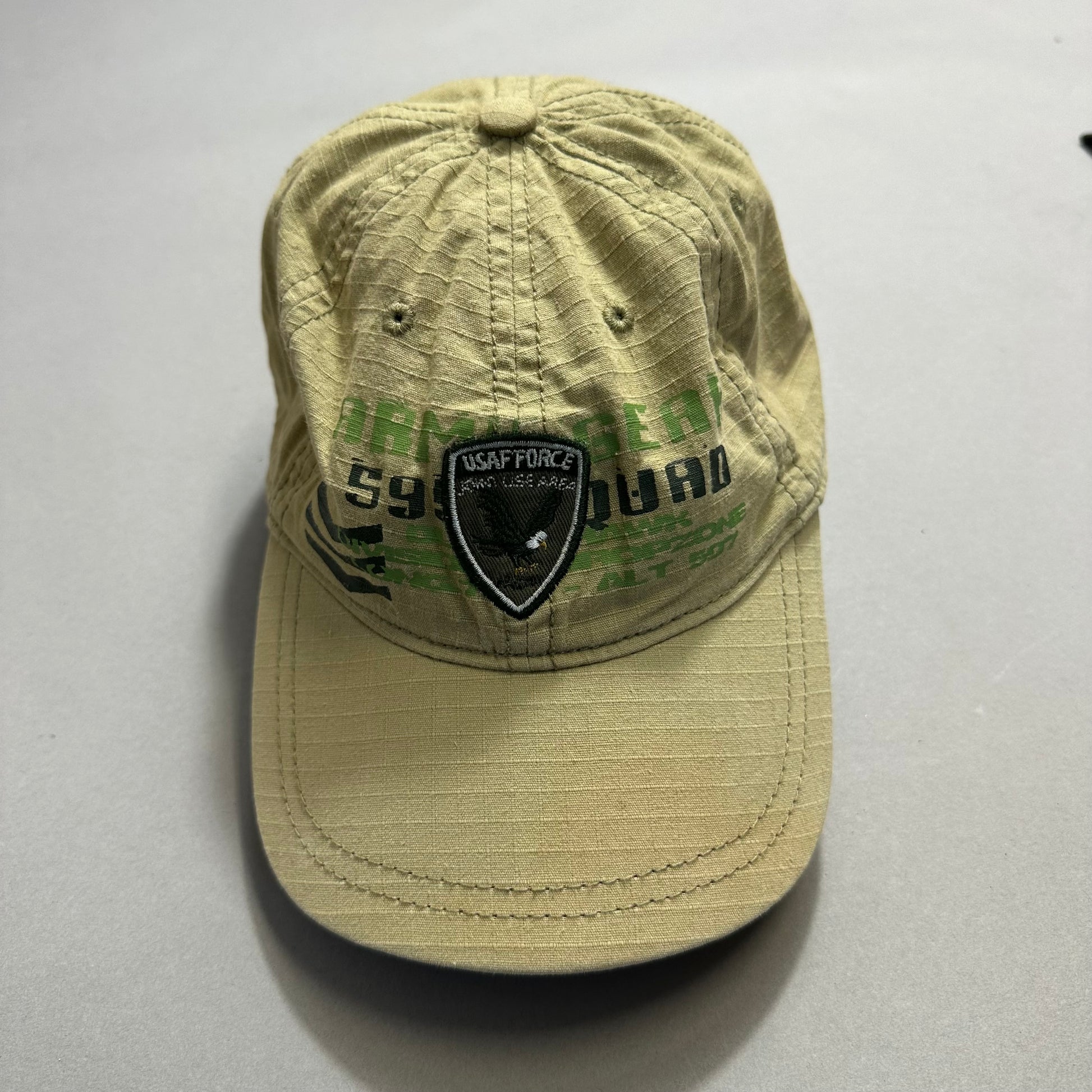Beige cap with black and green nullUSAF FORCEnull emblem on the front.