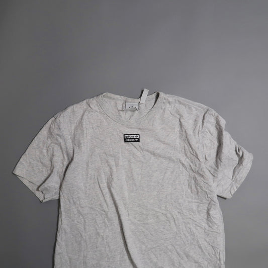 Gray T-shirt with an Adidas logo on a plain background.