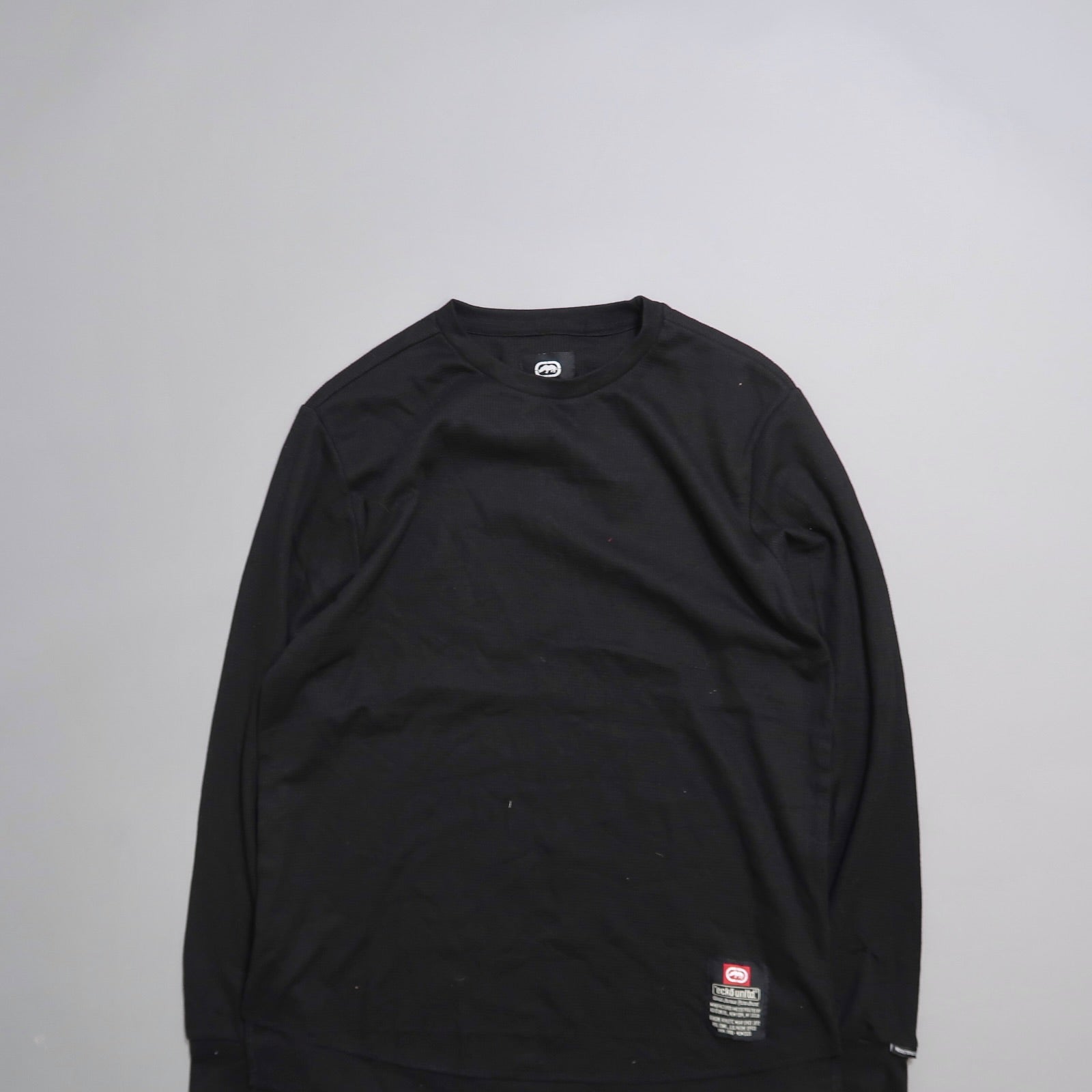Black long-sleeve shirt on a gray background.