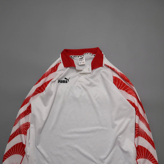 White Puma jersey with red collar and patterned sleeves.