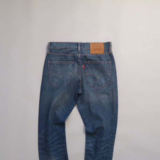 Blue jeans with Levi's logo on a gray background