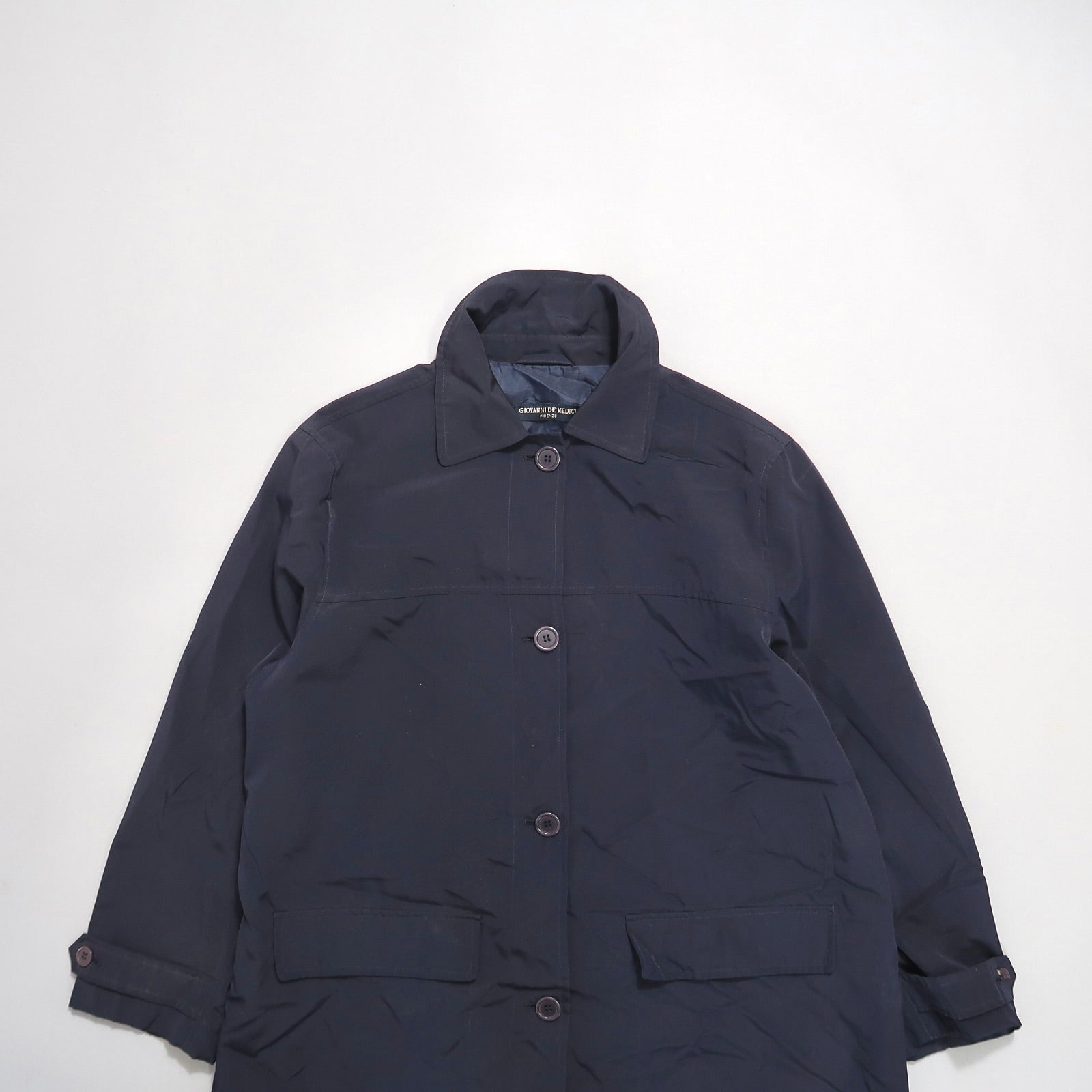 Dark navy button-up coat with collar and pockets.