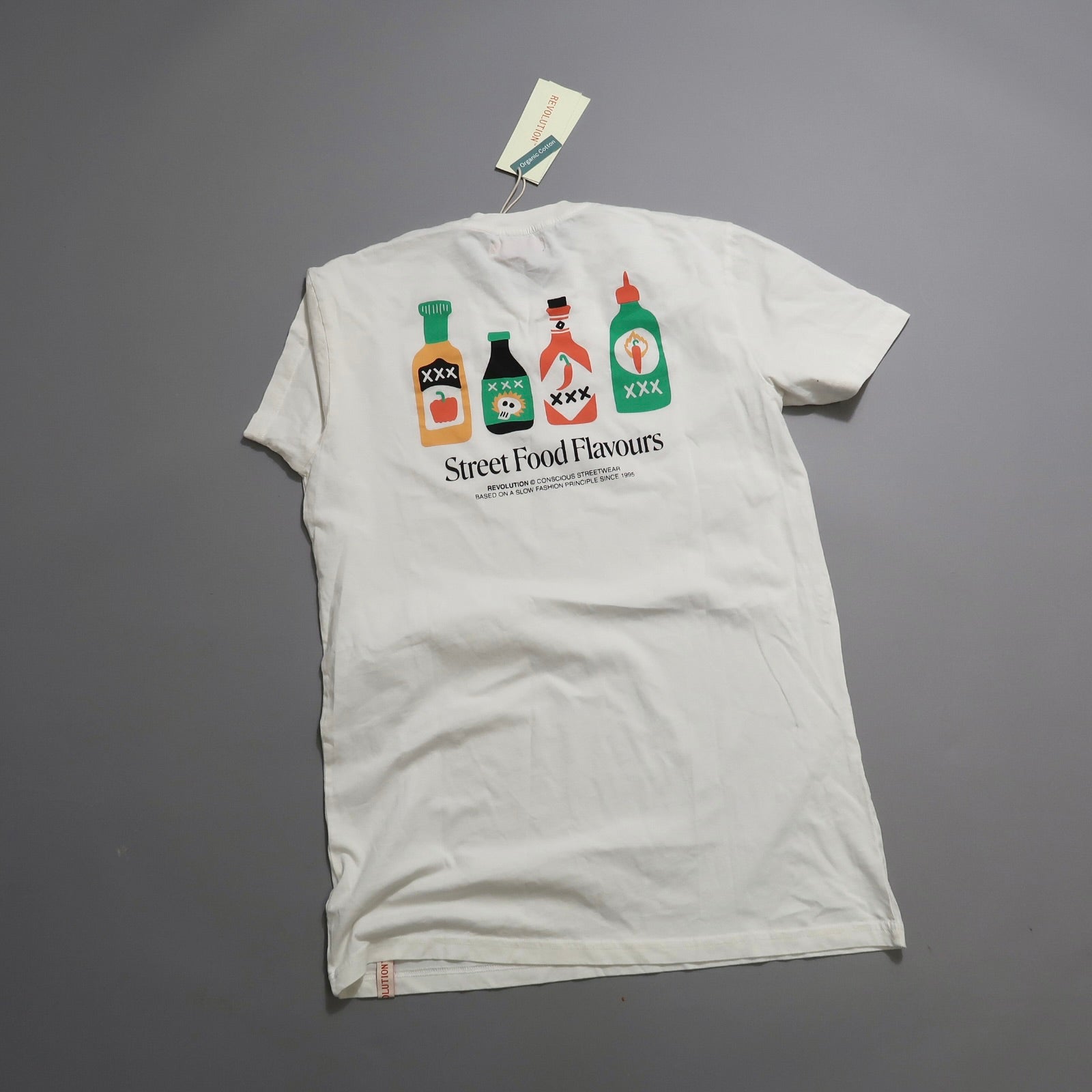 White T-shirt with colorful bottle designs, nullStreet Food Flavoursnull text.