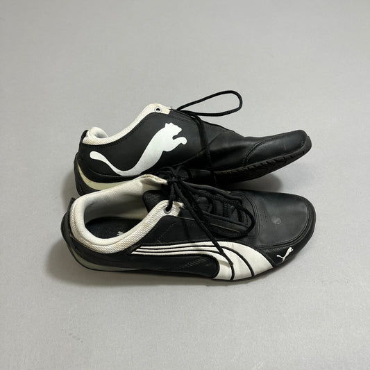 Black and white sports shoes with a pouncing cat logo.