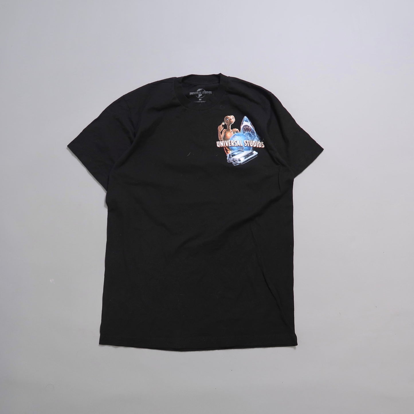 Black T-shirt with Universal Studios logo and movie-themed graphics.