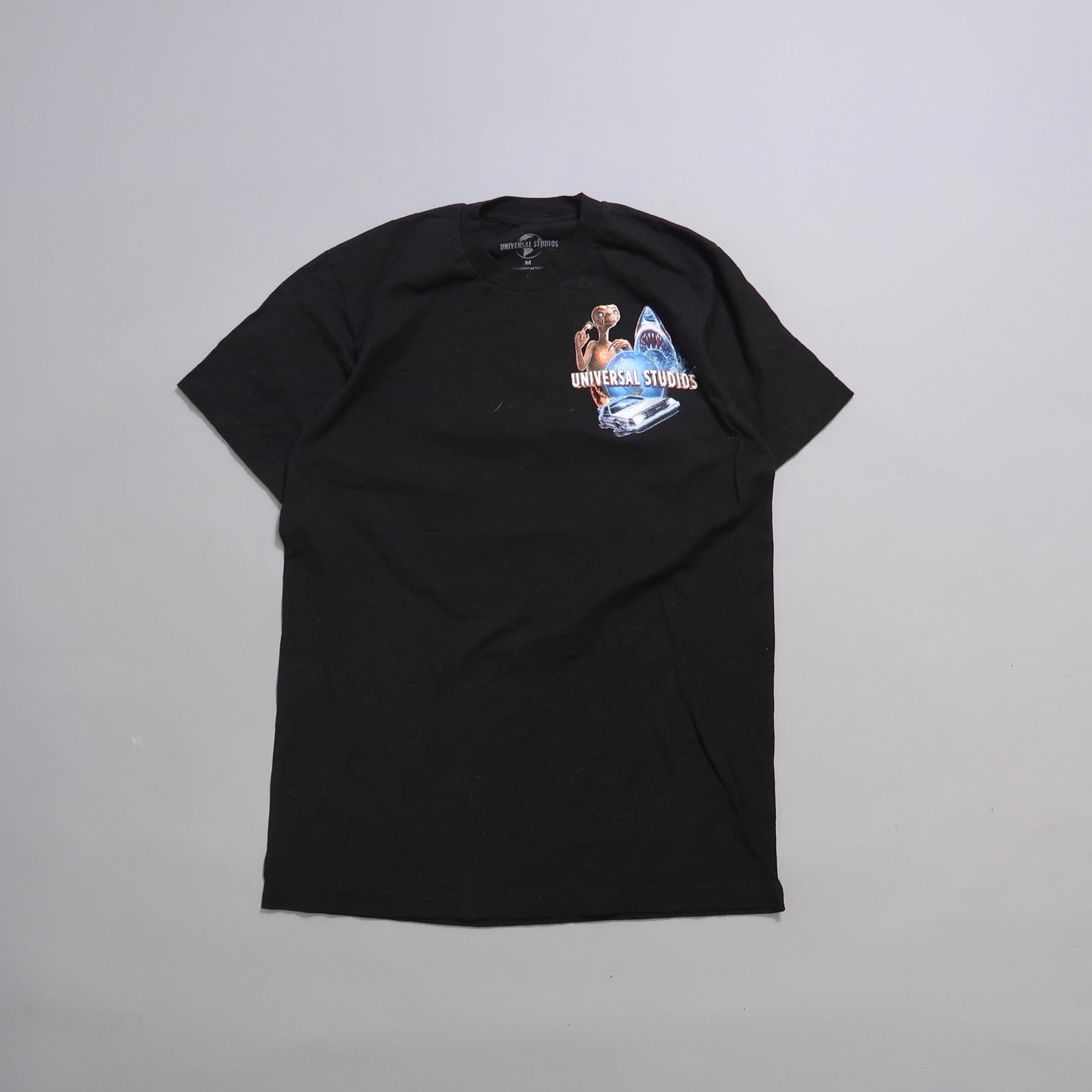 Black T-shirt with Universal Studios logo and movie-themed graphics.