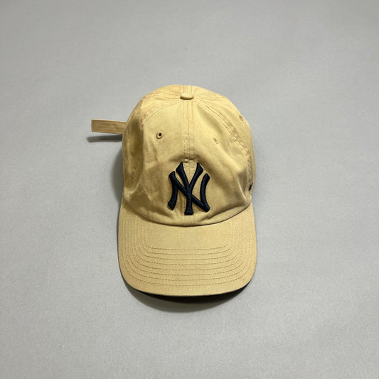 Beige baseball cap with a navy nullNYnull logo on the front.
