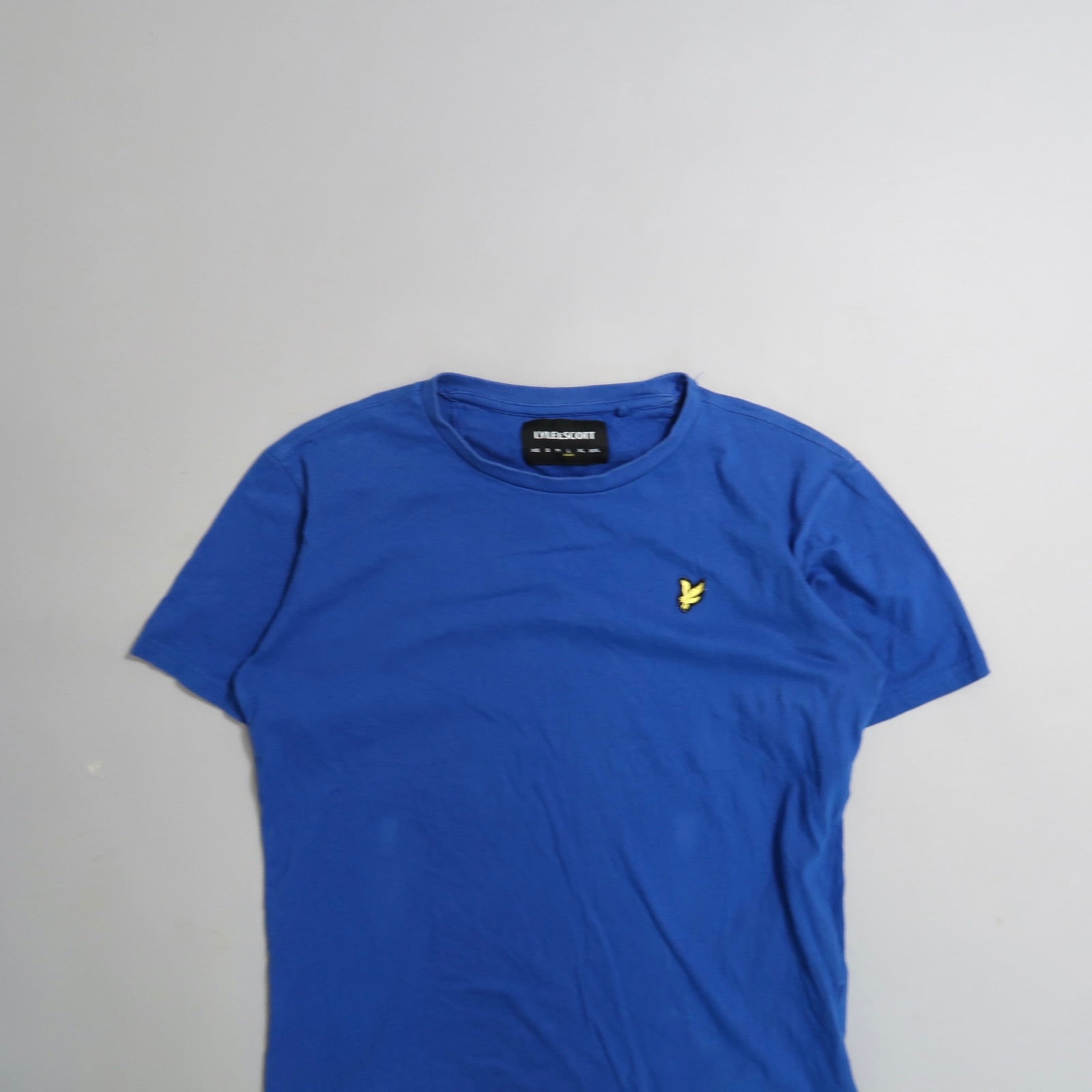 Blue t-shirt with yellow bird logo on the left chest.